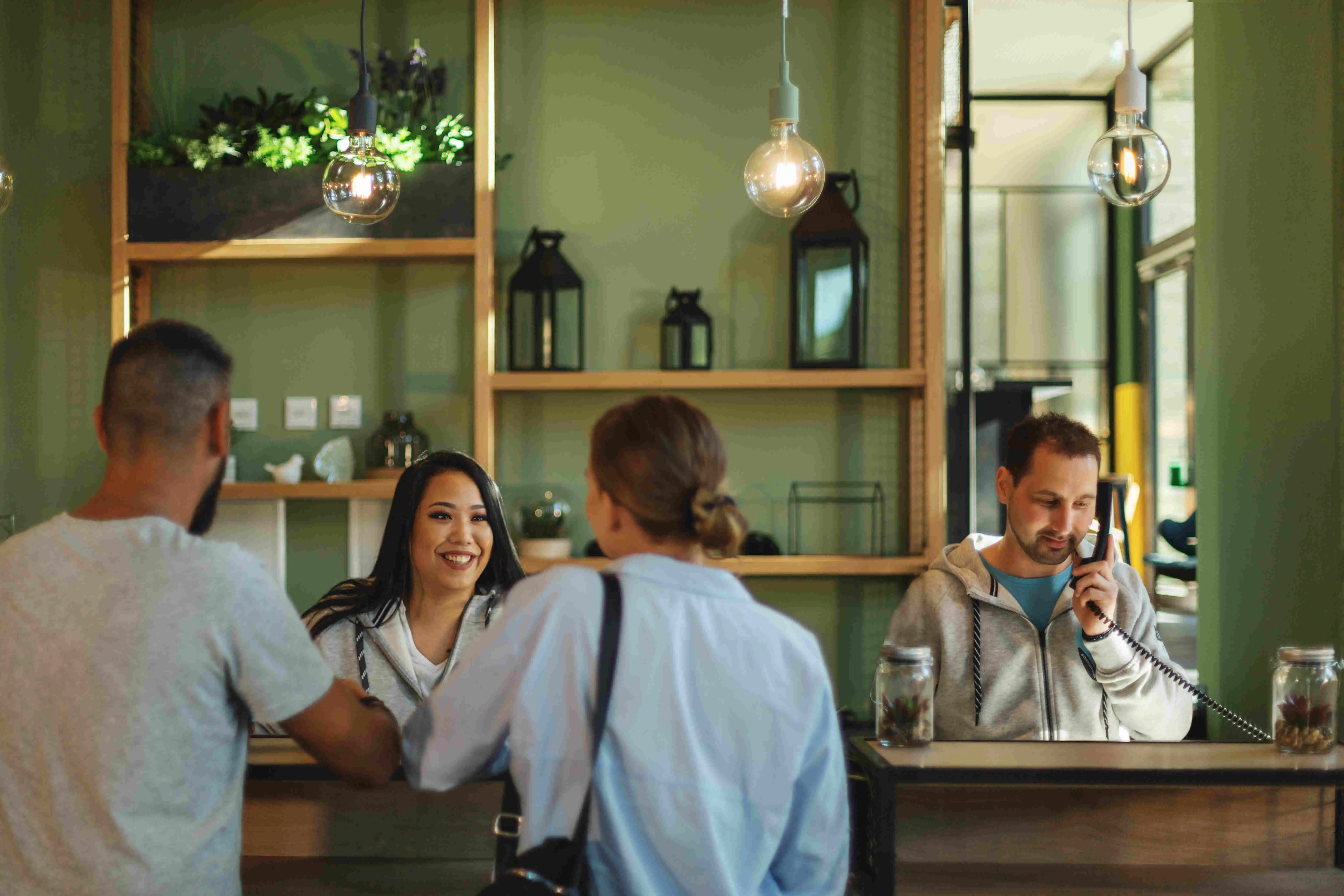 Check-in scene with several people against a green background